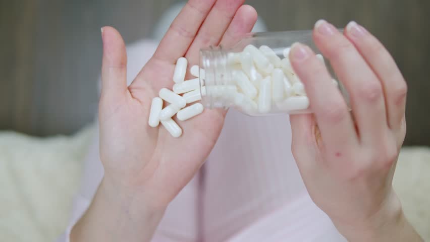 Pills and vitamins macro, Close up view of womans hands holding plenty of different drugs. Painkillers and antibiotics. Healthcare and medicine concept