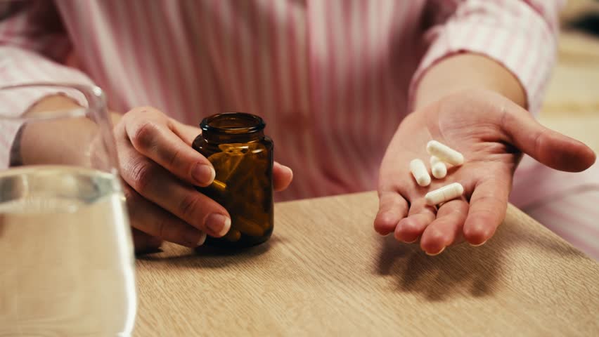 Pills and vitamins macro, Close up view of womans hands holding plenty of different drugs. Painkillers and antibiotics. Healthcare and medicine concept