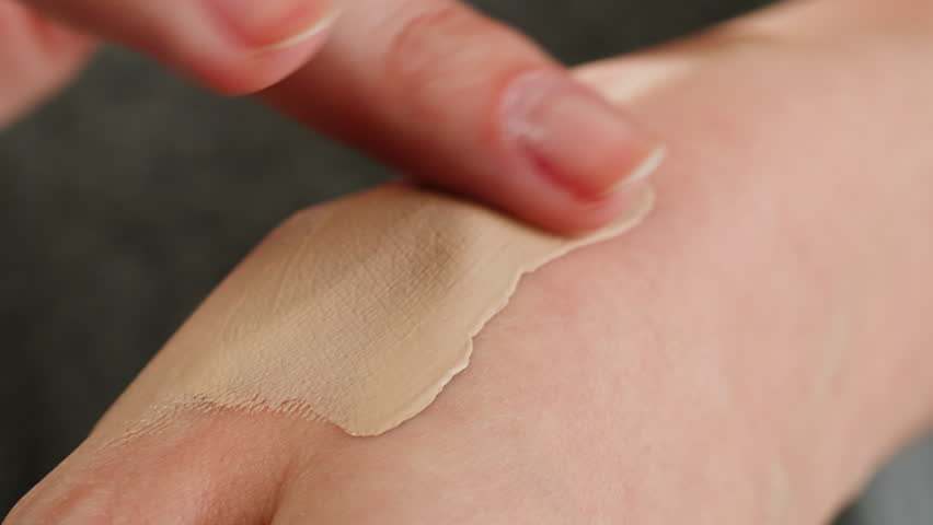 Young Woman Check Choosing Hand Skin Care Cream in Cosmetics Supermarket, tone or lipstick checking.