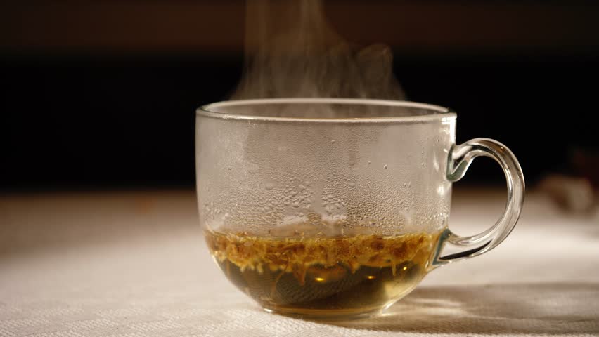 Steaming hot up of chamomile tea medium 4k shot selective focus