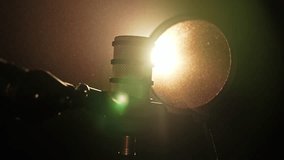 Professional Microphone with Pop Filter in Warm Studio Light - Powered by Shutterstock - Get 15% off with code: PIKWIZARD15