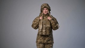 A brave female soldier showcases military gear and uniform in an action demonstration. female soldier of the Ukrainian army - Powered by Shutterstock - Get 15% off with code: PIKWIZARD15