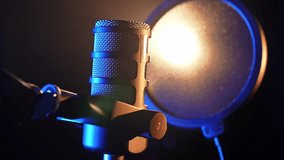 Professional studio microphone with pop filter in dramatic lighting - Powered by Shutterstock - Get 15% off with code: PIKWIZARD15