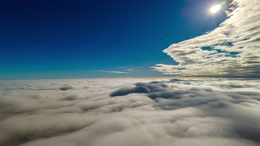 Above the clouds timelapse showing endless rolling mist and a clear blue sky
