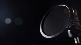 Professional studio microphone with pop filter in warm lighting - Powered by Shutterstock - Get 15% off with code: PIKWIZARD15