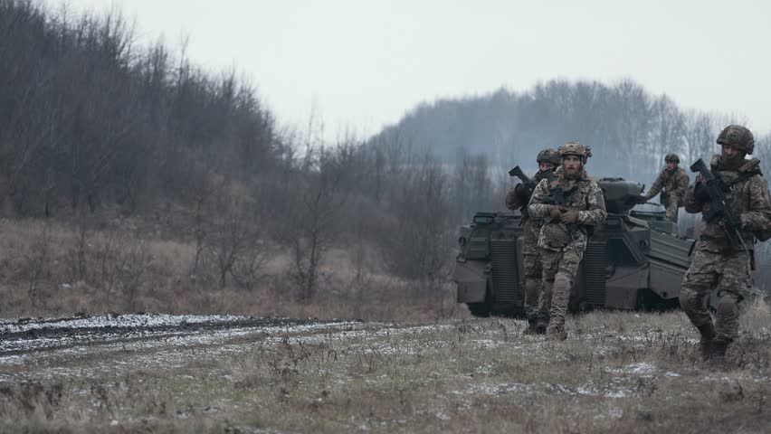 Ukrainian infantrymen move with armored vehicles