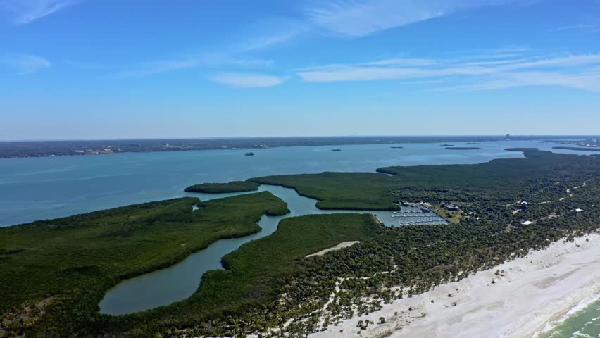 Aerial footage capturing the winding waterways and lush mangrove forests of Caladesi Island. The pristine coastal ecosystem contrasts with the white sandy shores, showcasing Florida’s natural beauty.