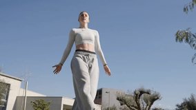 Young woman performing parkour acrobatics in urban park - Powered by Shutterstock - Get 15% off with code: PIKWIZARD15