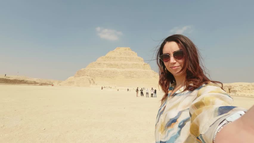 Tourist showing saqqara step pyramid in egypt