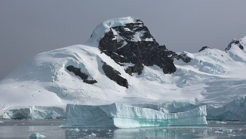 Majestic ice formations and towering cliffs in Antarctica captured during summer exploration
