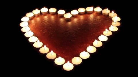 Fiery heart. Candles arranged in a heart shape light up, then go off 스톡 비디오