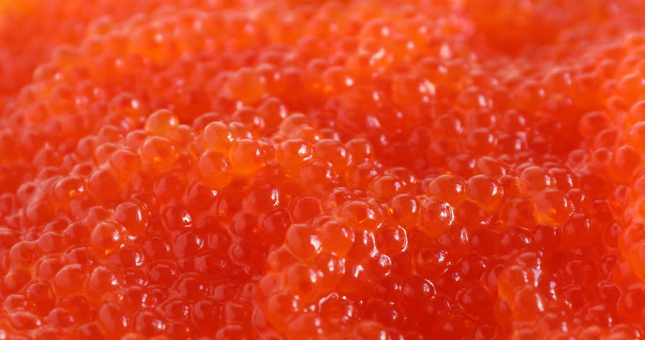 Taking tasty red caviar with spoon, closeup