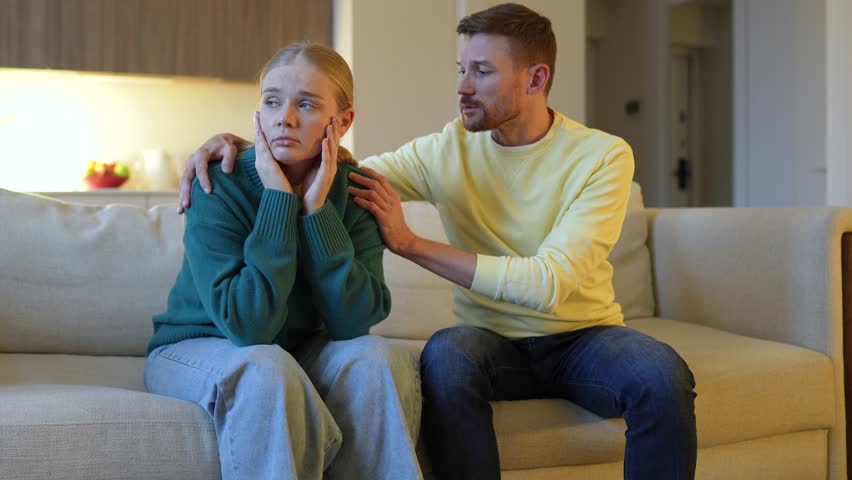 Devastated grieving wife sobs uncontrollably as husband hold embrace comfort her, emotional support. Shared sorrow, overwhelm sadness, deep loss, heartbreaking couple in distress, love and care