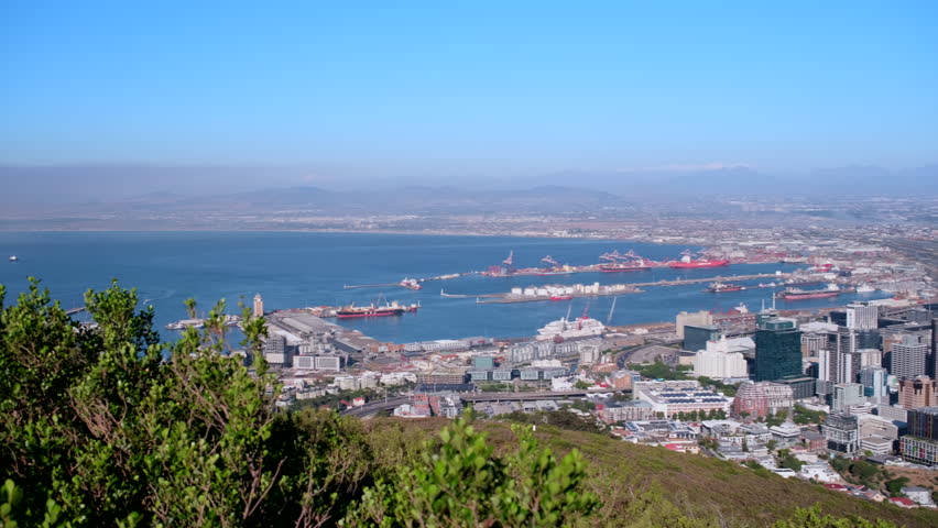 Panoramic view of Cape Town port and city bowl toward Table Mountain, pan shot