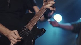 Professional guitarist performing dynamic electric guitar solo during energetic rock concert, capturing passionate musical expression in dramatic slow motion sequence - Powered by Shutterstock - Get 15% off with code: PIKWIZARD15