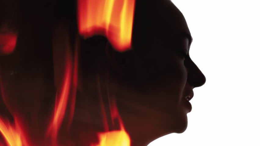 Burning silhouette. Nervous breakdown. Anger fierce. Fire flame smoke in dark double exposure profile outline of frustrated woman yelling isolated on white.