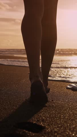 Beautiful Woman Walking on Marine Beach and Wet Legs Shape Moving Closeup. One Adult Girl at Bright Scenic Sea Going Swim or Splash. Modern Romance of Ocean Bathing and Amazing Summer Sky at Sundown