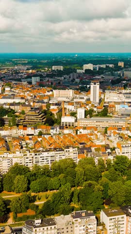 Vertical video. Ghent, Belgium. Panorama of the central city from the air. Cloudy weather, summer day, Aerial View, Departure of the camera. Rich colors