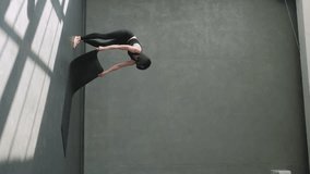 Vertical video. Yoga class. Sport training. Group people in activewear with athletic woman instructor unroll fitness mat before workout exercise in gym studio indoors. - Powered by Shutterstock - Get 15% off with code: PIKWIZARD15