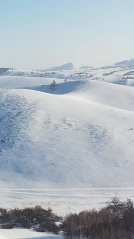 Vertical Aerial video view from drone on winter snow landscape natural background. Biryuksinsky mountain pass in Altai. 