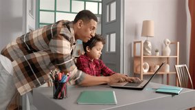 Smart concentrated African American schoolboy and caring attractive black father studying lesson online using laptop pc, discussing educational material at home. - Powered by Shutterstock - Get 15% off with code: PIKWIZARD15