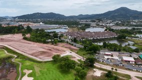 Aerial footage showcases a golf course under construction in Phuket, Thailand, highlighting lush greenery and surrounding landscapes - Powered by Shutterstock - Get 15% off with code: PIKWIZARD15