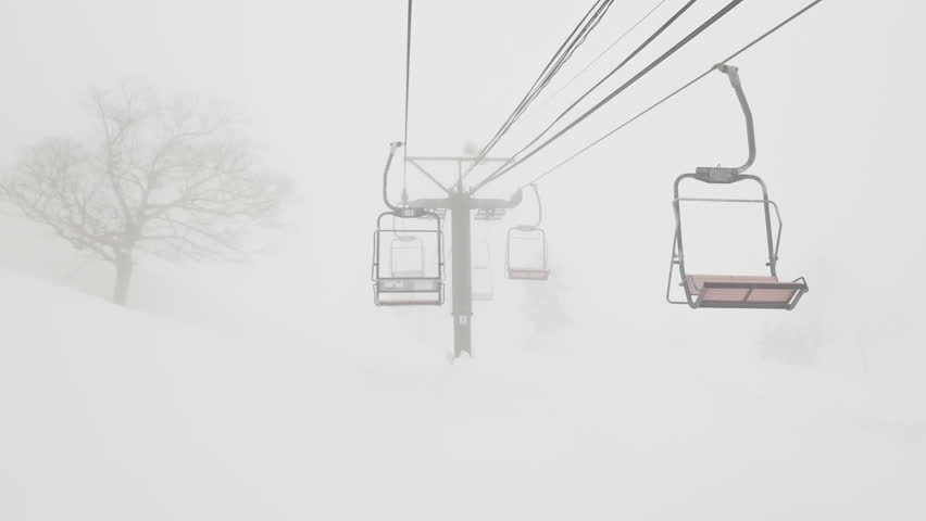 Ski lift POV shot in thick fog and low visibility