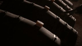 Aged wooden barrels with a wine in a former stone quarry, row of wine barrels at a vintage winery, Wine preparation and fermenting process - Powered by Shutterstock - Get 15% off with code: PIKWIZARD15