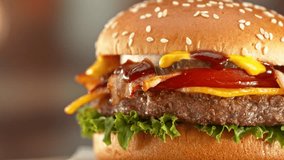 Delicious Hamburger with Cheese in Motion. Fresh Fast Food with Beautiful Bokeh Kitchen Background. Cheeseburger Ready to Eat. - Powered by Shutterstock - Get 15% off with code: PIKWIZARD15