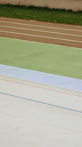 Cyclists training riding on velodrome. Bicycle race on cycling track. Velodrome competition. Vertical video