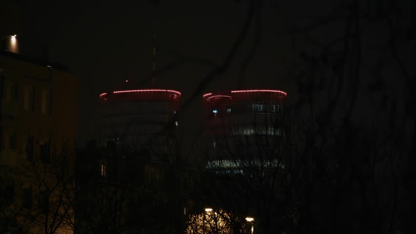 Illuminated twin towers with red lights contrast the dark night sky in Zagreb