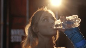 Sporty girl drinks water after a workout in the gym - Powered by Shutterstock - Get 15% off with code: PIKWIZARD15