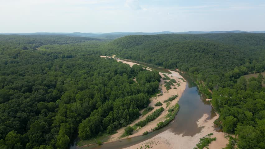 Drone footage of the Black River in southeastern Missouri. The river bends around the feet of the Ozark Mountains as they march off into the distance.