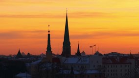 Snow-covered rooftops and historic church spires glow in Riga’s sunrise light - Powered by Shutterstock - Get 15% off with code: PIKWIZARD15
