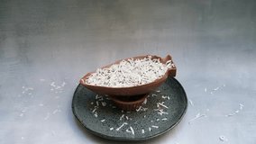 Grated coconut falling on a milk chocolate Easter egg. - Powered by Shutterstock - Get 15% off with code: PIKWIZARD15