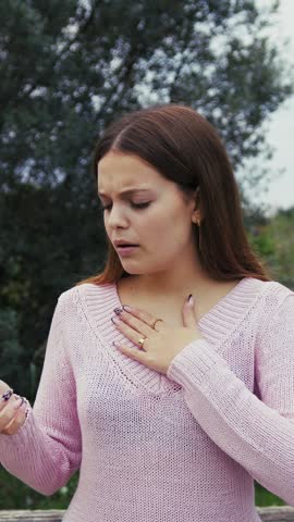 Girl Eats Sour Food And Grimaces In Disgust Outdoors