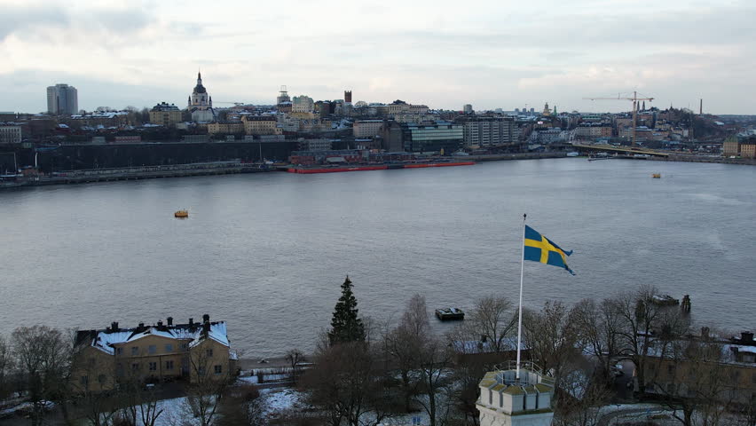 Drone view of Swedish flag on top of Kastellet Castle on Kastellholmen, Stockholm, Sweden in Winter.