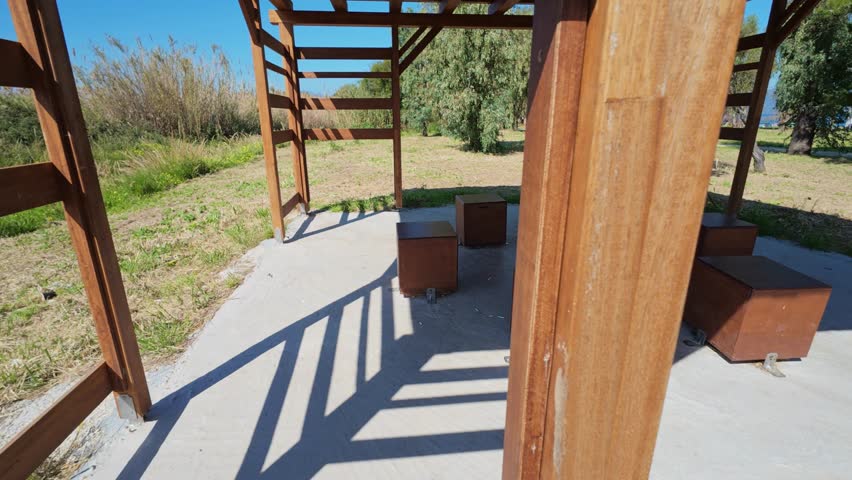 Resting area with wooden pergola in green park