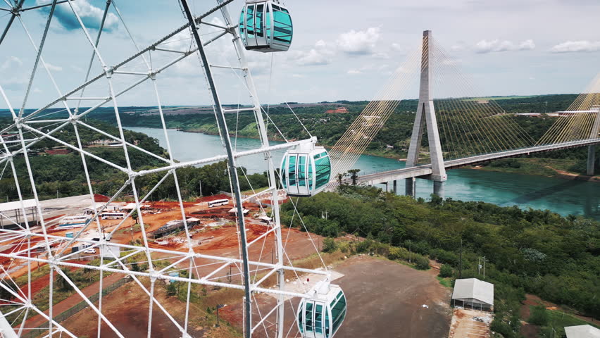 Observing wheel on the triple frontier area. Brazil, Argentina, Paraguay. Aerial view of the area near the borders of three countries with local landmarks - The Integration Bridge and giant ferris