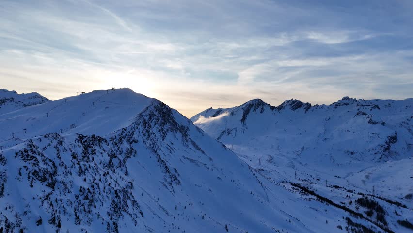 Beautiful drone footage of snowy mountains in the Alps (La Thuile-Mont Blanc, Italy). [Drone movement: pitch backwards]