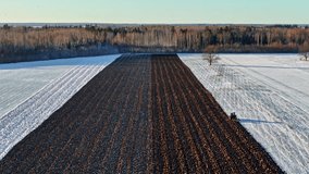 Farmer working on land covered in snow, aerial drone view - Powered by Shutterstock - Get 15% off with code: PIKWIZARD15