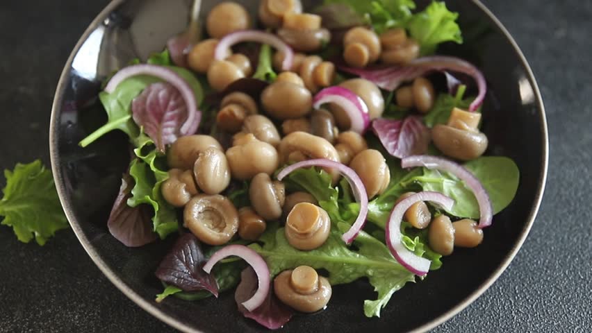 Salad mushroom champignon lettuce green fresh gourmet food background on the table rustic food top view copy space keto and paleo diet vegetarian and vegan food