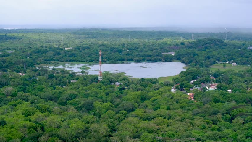 Aerial view of landscape at Mihintale near Anuradhapura in Sri Lanka with large lake of water and forest tree covered terrain