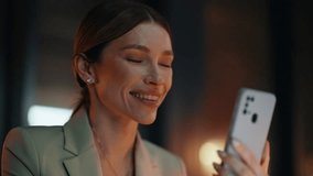 Evening lady worker hand holding smartphone in office closeup. Relaxed corporate manager woman reading ebook on mobile phone at dark workplace. Smiling businesswoman watching social media cellphone  - Powered by Shutterstock - Get 15% off with code: PIKWIZARD15