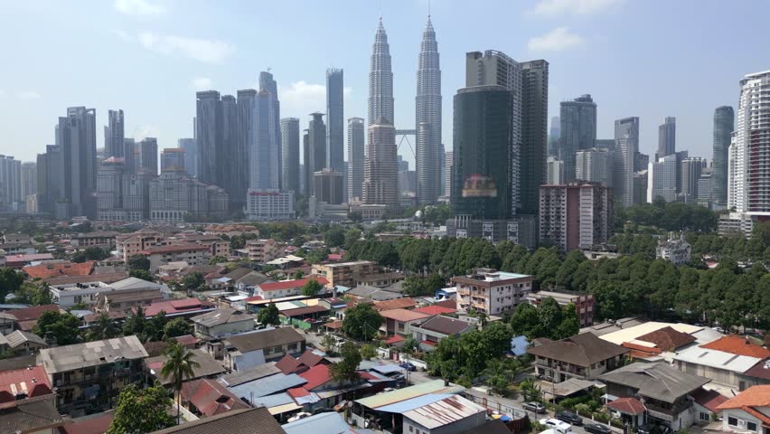 Aerial view of Kuala Lumpur city skyline with skyscrapers and urban buildings in Malaysia.