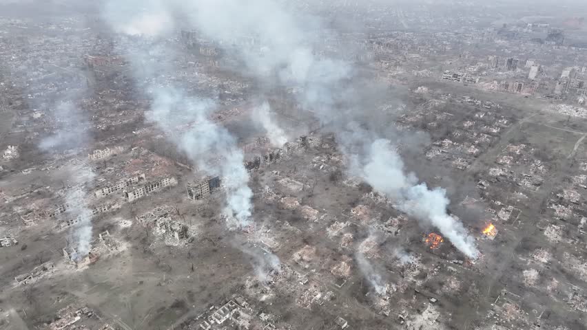 Aerial view of Toretsk city ruins, Donetsk region, Ukraine, March 2025. Drone footage of destroyed residential buildings, smoke from fires, and total urban devastation during the Russo-Ukrainian war frontline operations.