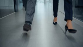 Businesspeople feet walking modern empty corridor closeup. Unrecognizable business colleagues stepping on grey floor hurrying to office work. Elegant pair managers legs strolling corporate vestibule  - Powered by Shutterstock - Get 15% off with code: PIKWIZARD15