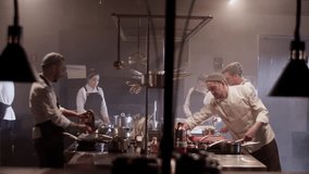 Group of chefs cooking food together in kitchen - Powered by Shutterstock - Get 15% off with code: PIKWIZARD15