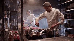 Team working together in kitchen of restaurant - Powered by Shutterstock - Get 15% off with code: PIKWIZARD15