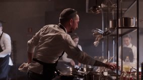 Male chef cooking food in commercial kitchen - Powered by Shutterstock - Get 15% off with code: PIKWIZARD15